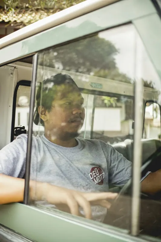 A vetted TransportPlus driver at the wheel of a commuter shuttle