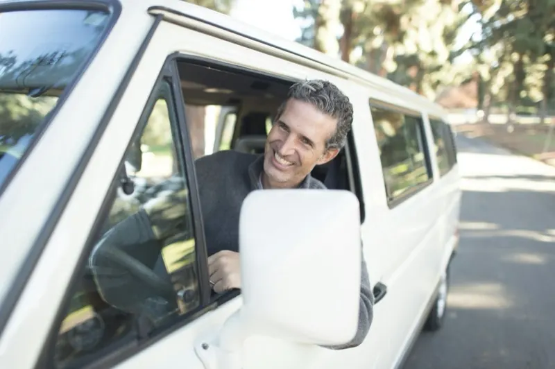 A TransportPlus driver at the window of a passenger vehicle